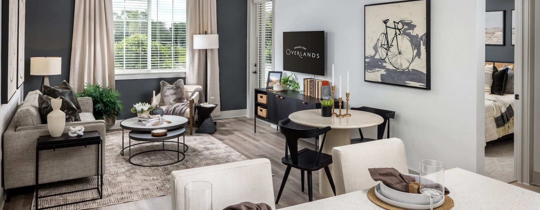 living area with a couch, table and large window